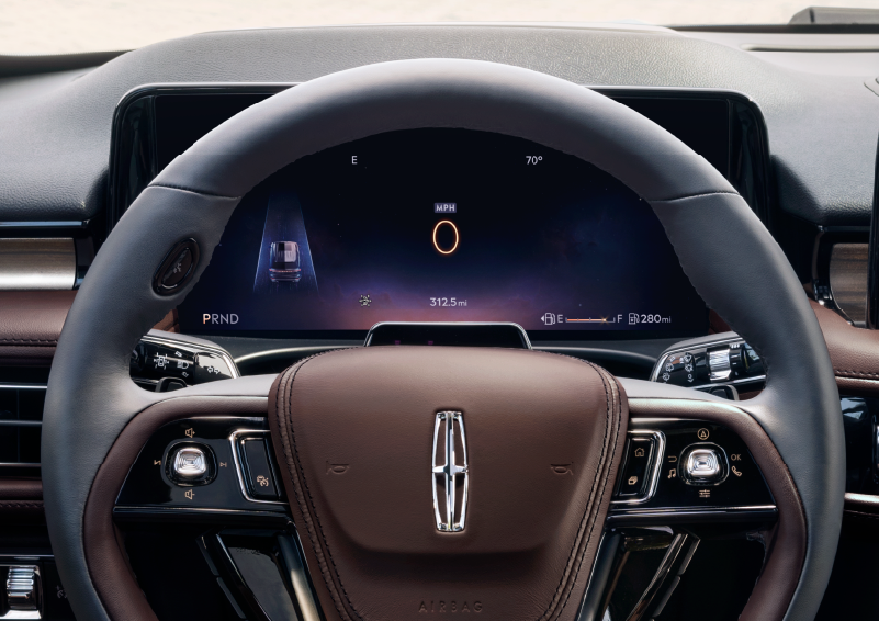 The steering wheel of 2025 Lincoln Aviator® SUV is shown with black and brown accents. | Stuteville Lincoln of Ponca City in Ponca City OK