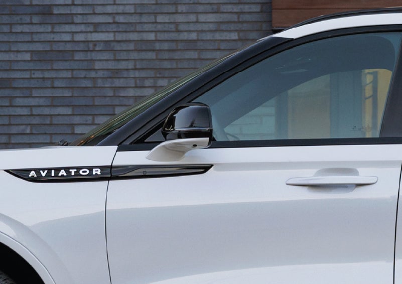 The driver’s side door and fender badging of a white 2026 Lincoln Aviator® SUV are showcased. | Stuteville Lincoln of Ponca City in Ponca City OK